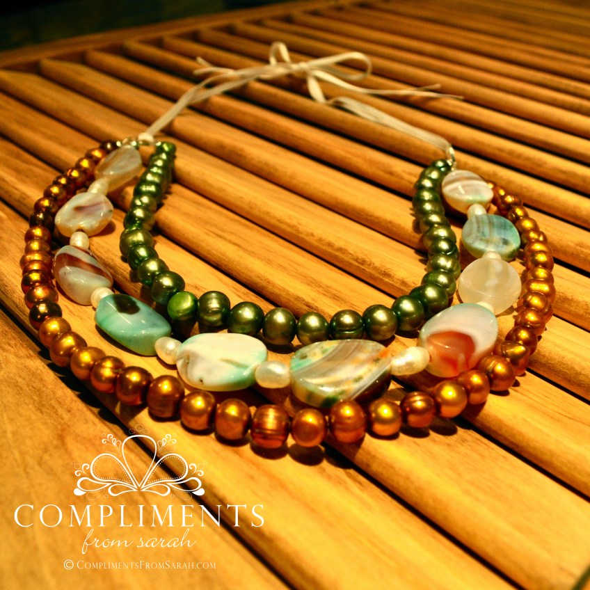 multi colored pearl and stone necklace on ribbon