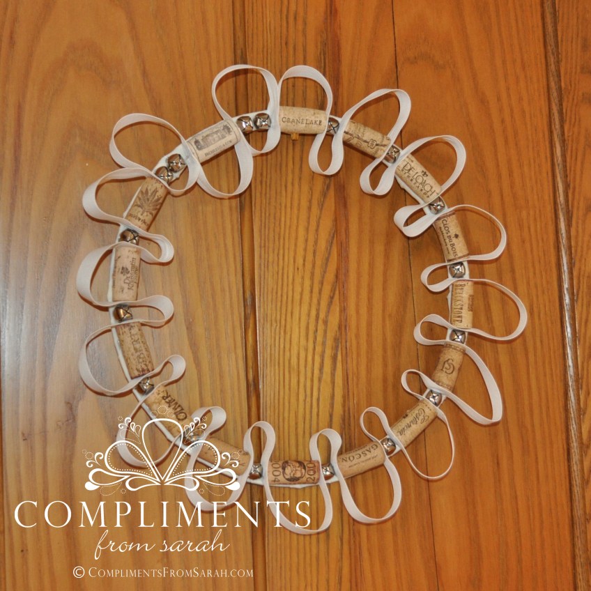 whimsical wine cork wreath with white ribbon