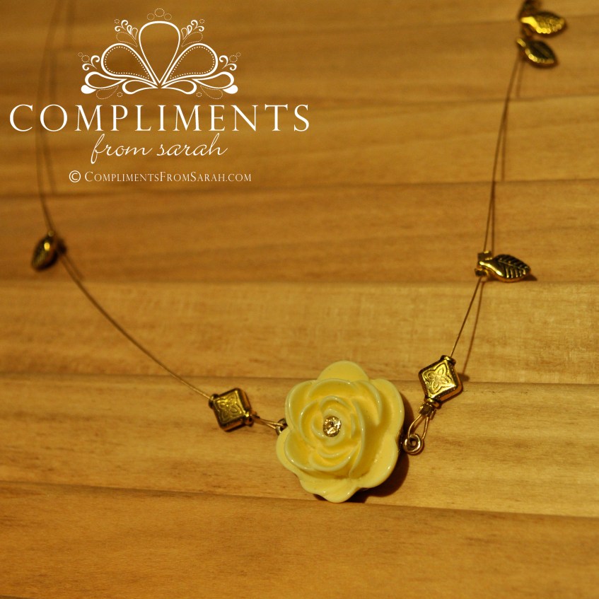 yellow rose pendant on gold leaf necklace